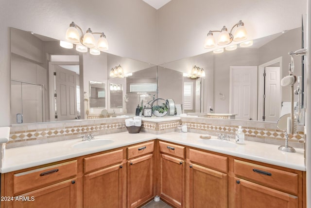 bathroom with decorative backsplash, an enclosed shower, and vanity