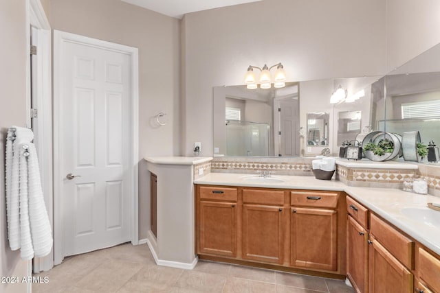 bathroom featuring tile patterned floors, vanity, and a shower with shower door