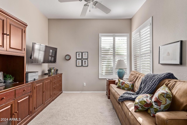 carpeted living room with ceiling fan