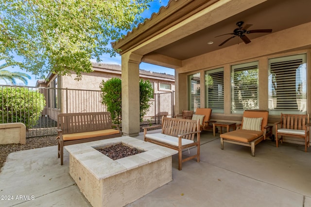 view of patio with ceiling fan and an outdoor living space with a fire pit