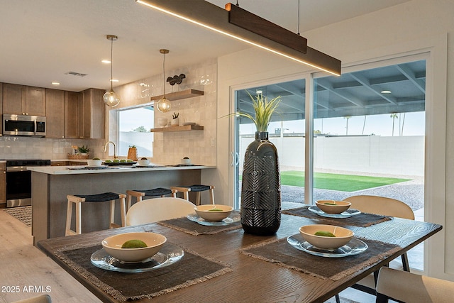 dining area with light hardwood / wood-style flooring