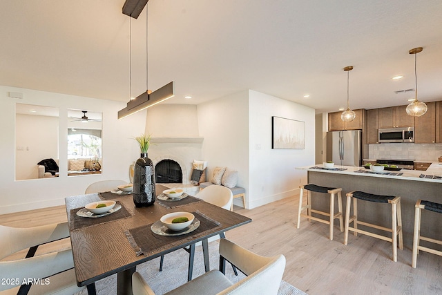 dining space featuring light hardwood / wood-style flooring and ceiling fan