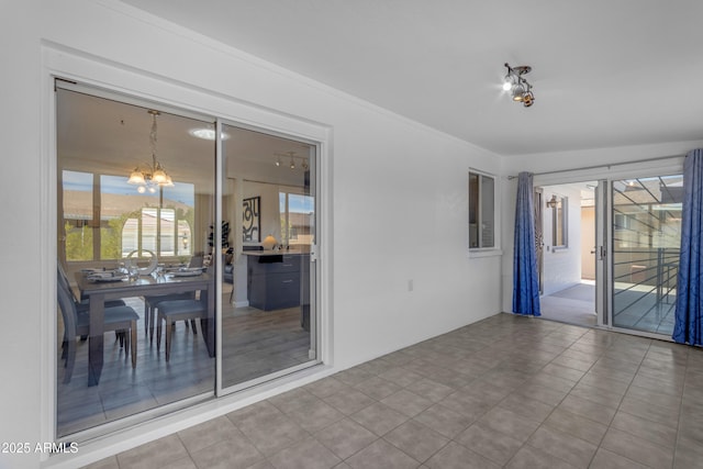 unfurnished room with a chandelier and ornamental molding