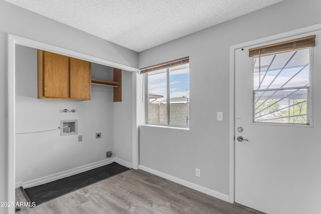 laundry room with baseboards, light wood-style flooring, hookup for a washing machine, a textured ceiling, and hookup for an electric dryer