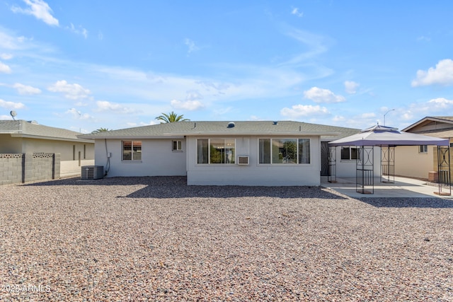 back of property with a gazebo, central AC unit, a patio area, and fence