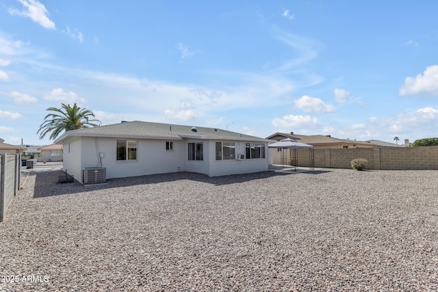 rear view of house featuring a gazebo, central AC, a patio area, and a fenced backyard