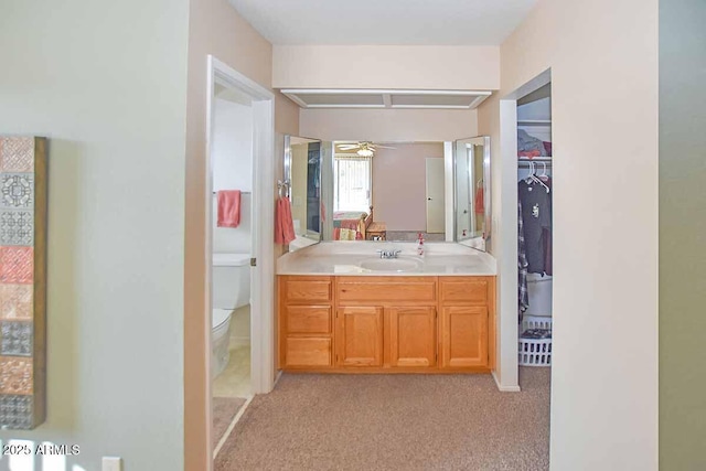 bathroom with vanity, ceiling fan, and toilet