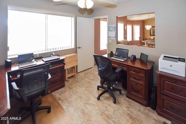 office featuring ceiling fan with notable chandelier