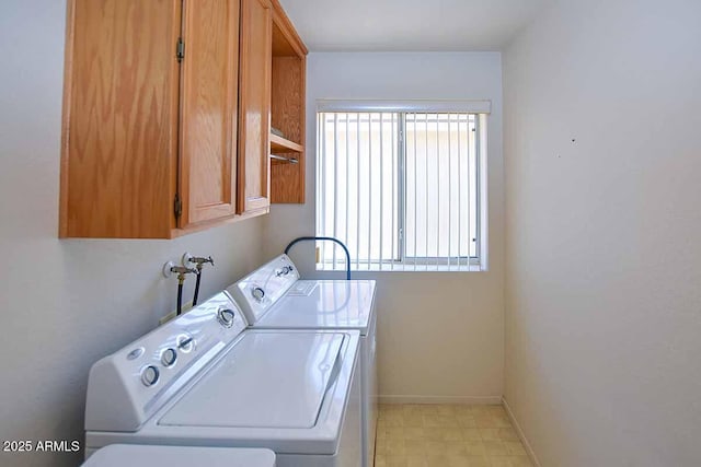 washroom featuring a wealth of natural light, cabinets, and washing machine and clothes dryer