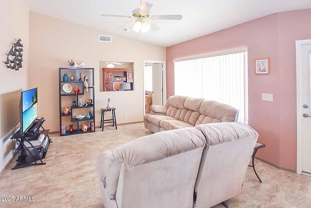 living room featuring ceiling fan and vaulted ceiling