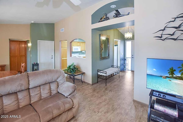 living room with high vaulted ceiling