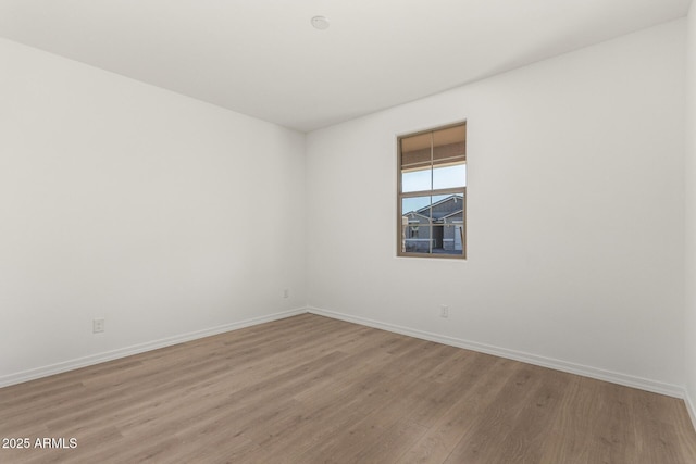 spare room featuring light hardwood / wood-style flooring