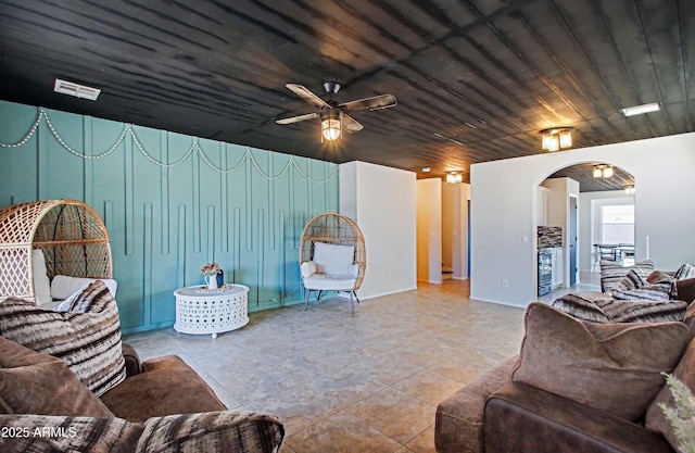 living room featuring ceiling fan, light tile patterned floors, and wood ceiling