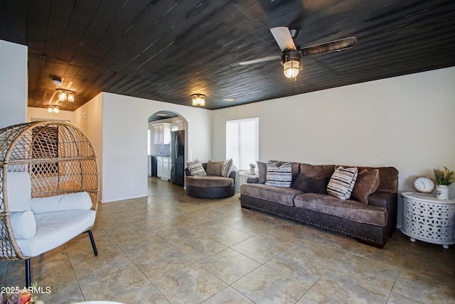 tiled living room with wood ceiling and ceiling fan