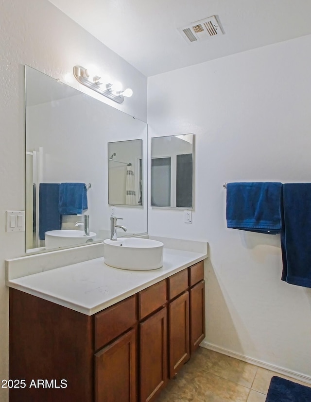 bathroom featuring vanity, tile patterned floors, and toilet