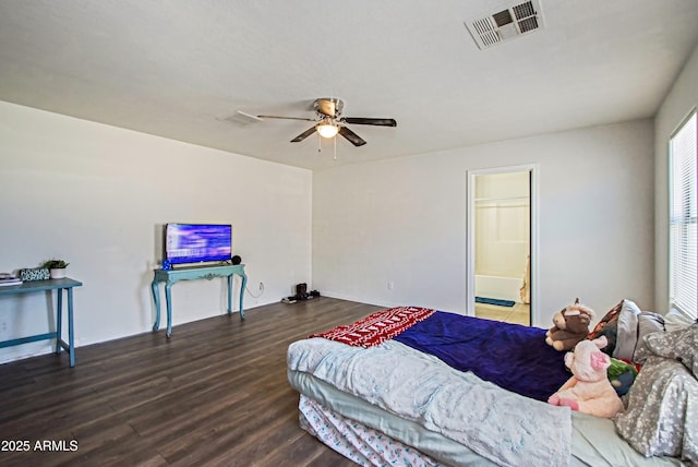 bedroom featuring dark wood-type flooring, ceiling fan, and ensuite bathroom