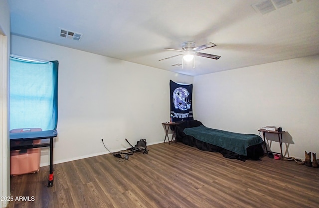 bedroom with dark hardwood / wood-style floors and ceiling fan