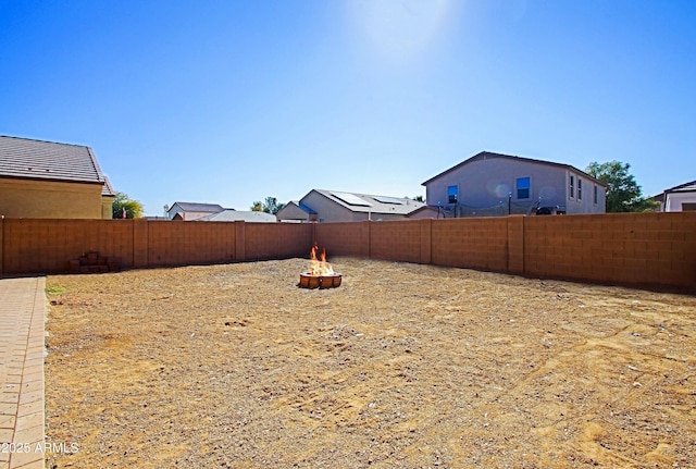 view of yard with a fire pit