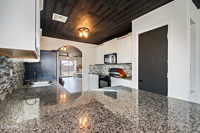 kitchen featuring sink, wood ceiling, black appliances, dark stone countertops, and white cabinets