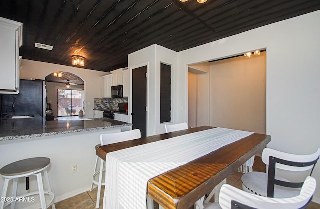 dining space featuring sink, wooden ceiling, ceiling fan, and light tile patterned flooring