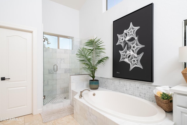 bathroom with independent shower and bath and tile patterned flooring