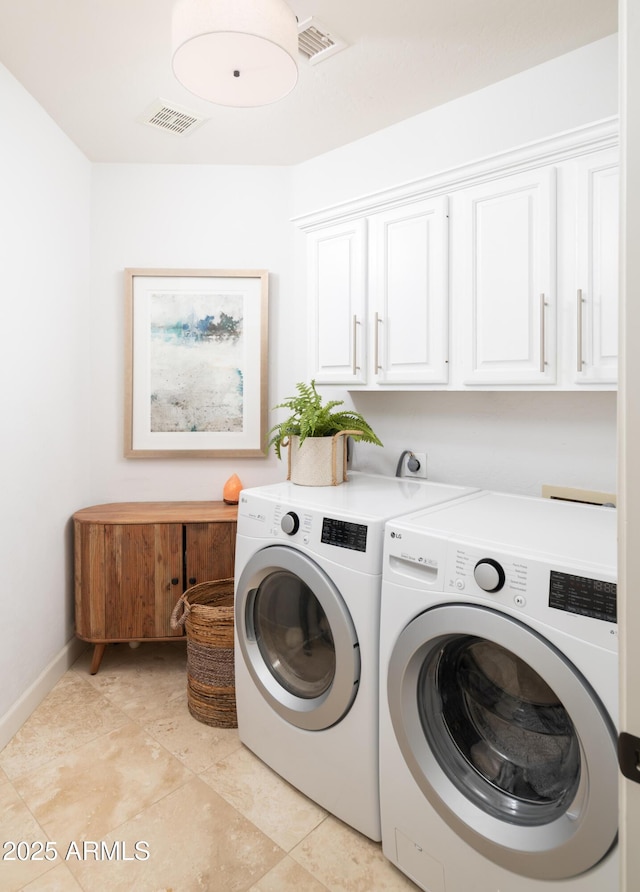 laundry room with cabinets and washing machine and clothes dryer