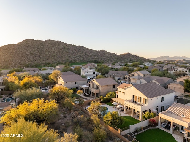 aerial view at dusk featuring a mountain view