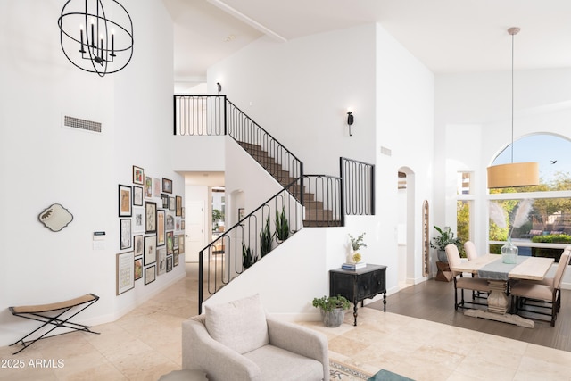 interior space featuring a towering ceiling and a notable chandelier