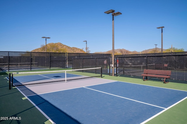 view of tennis court featuring a mountain view