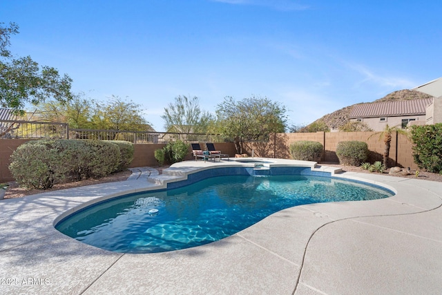 view of pool with a patio and an in ground hot tub