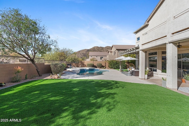 view of yard featuring a fenced in pool, a patio, and an outdoor hangout area