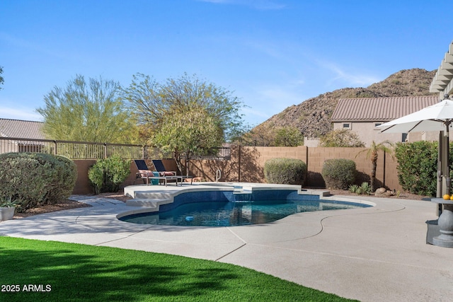 view of pool featuring a mountain view and a patio area