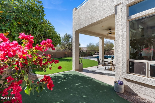 view of patio featuring ceiling fan