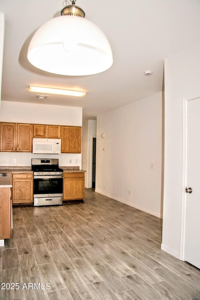 kitchen featuring dark wood-type flooring and electric stove