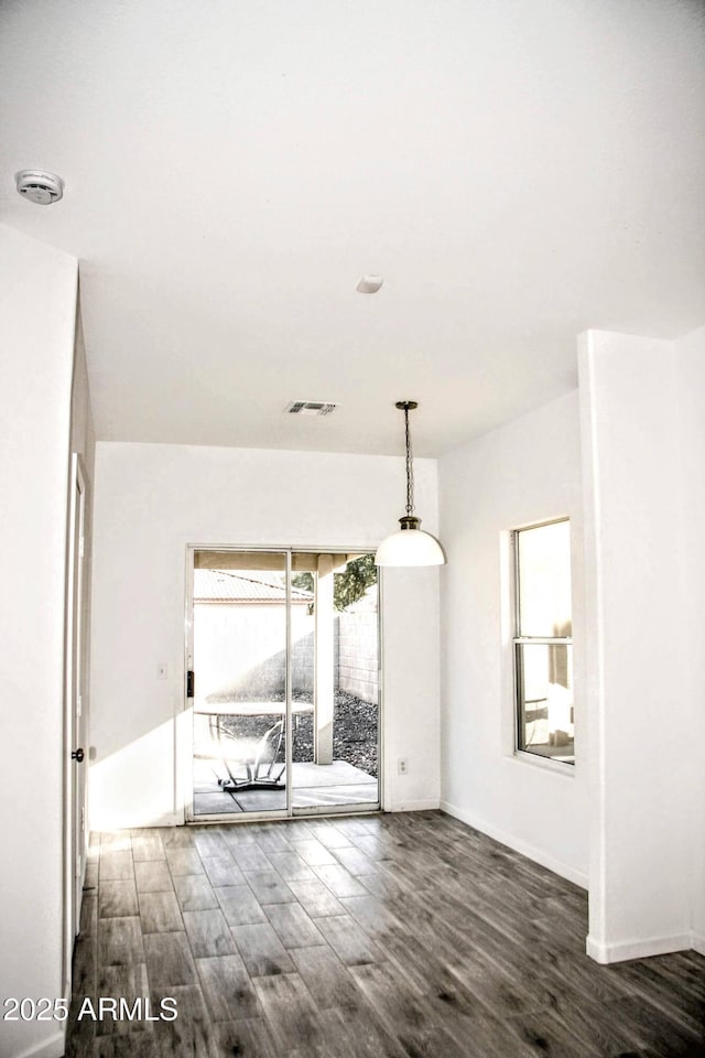 spare room with dark wood-type flooring