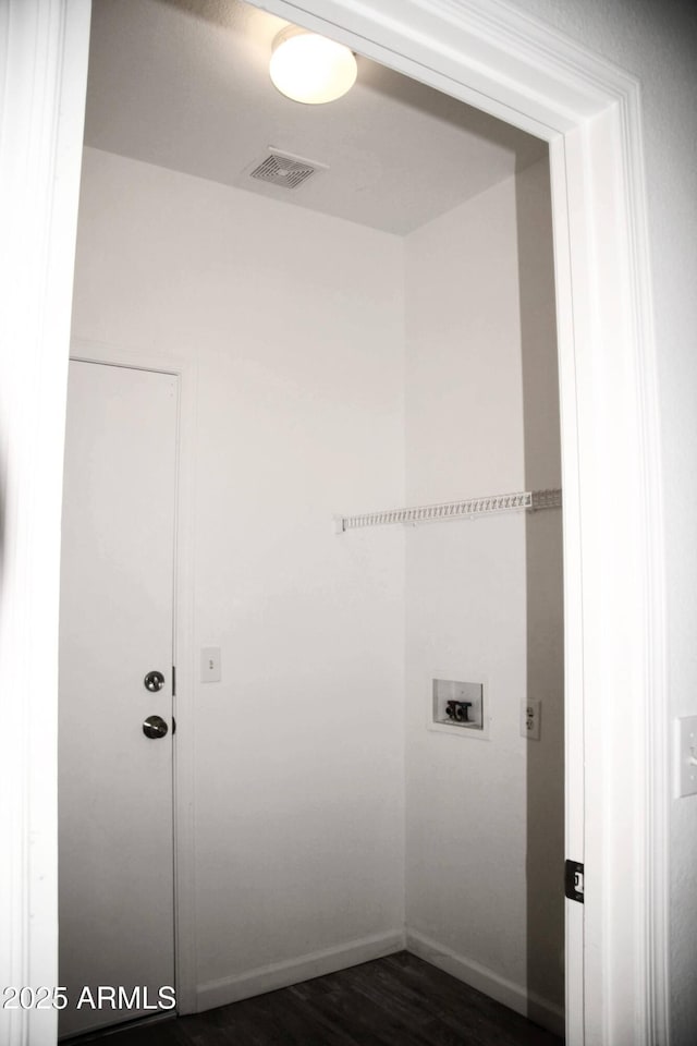 washroom featuring washer hookup and dark hardwood / wood-style flooring