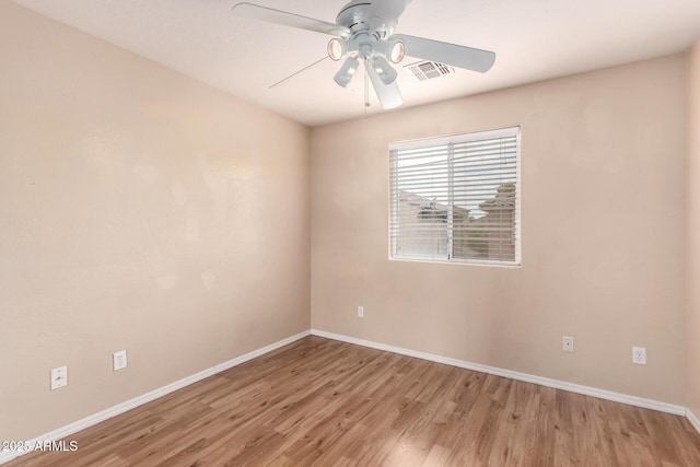 10 N 87th Dr, Tolleson, AZ 85353 - empty room with wood finished floors, baseboards, and a ceiling fan