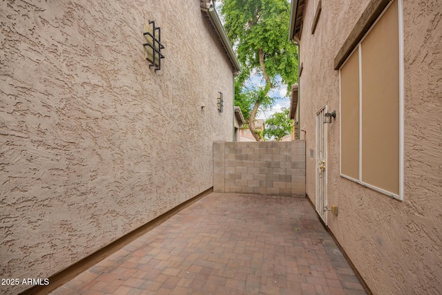 10 N 87th Dr, Tolleson, AZ 85353 - view of side of property featuring a patio, stucco siding, and fence