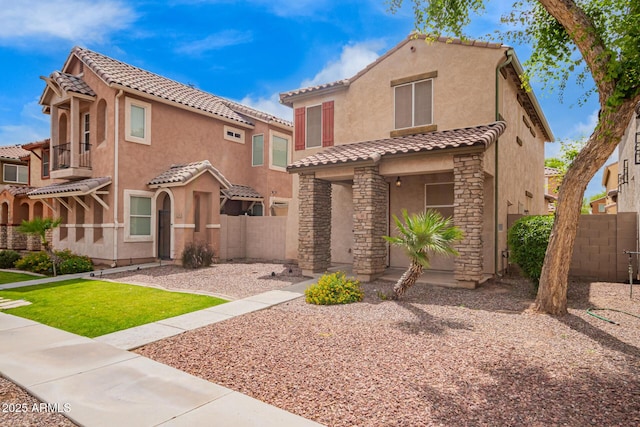 10 N 87th Dr, Tolleson, AZ 85353 - view of front of property featuring stucco siding, a tile roof, fence, and stone siding
