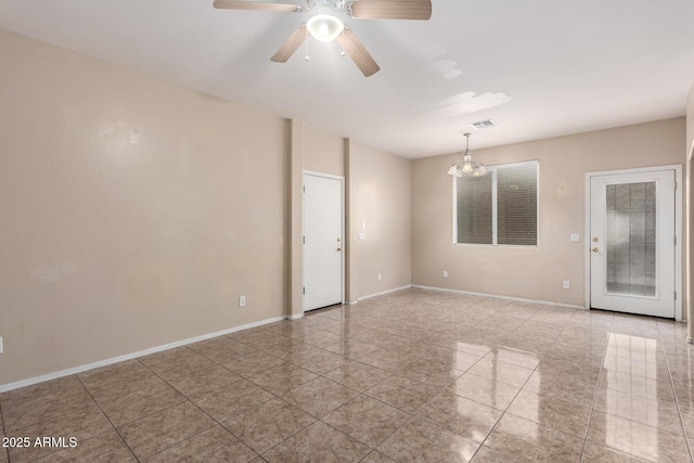 10 N 87th Dr, Tolleson, AZ 85353 - spare room featuring light tile patterned floors, a ceiling fan, and baseboards
