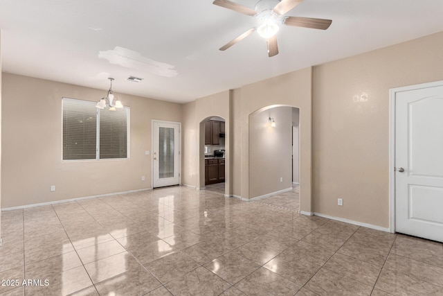 10 N 87th Dr, Tolleson, AZ 85353 - spare room featuring arched walkways, a ceiling fan, baseboards, and a chandelier