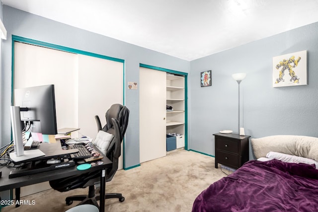 bedroom featuring carpet flooring and two closets