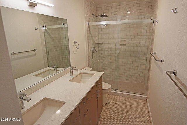 bathroom with tile patterned floors, walk in shower, toilet, and vanity