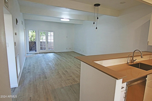 kitchen featuring dishwashing machine, decorative light fixtures, white cabinetry, french doors, and sink