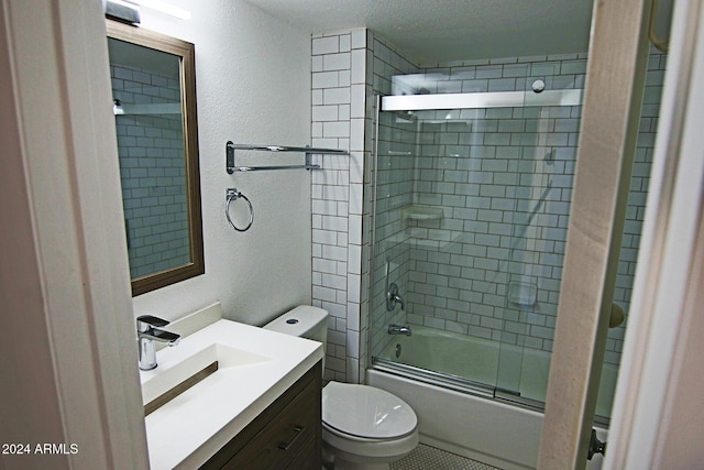 full bathroom featuring a textured ceiling, bath / shower combo with glass door, toilet, and vanity