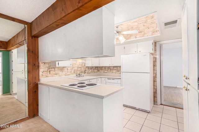 kitchen featuring white cabinets, white appliances, a textured ceiling, and light tile patterned floors