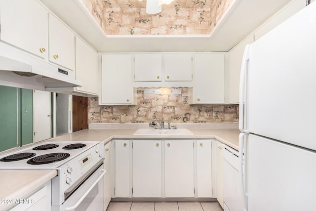 kitchen featuring light tile patterned flooring, white appliances, white cabinetry, and sink