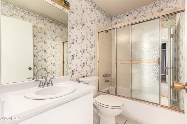 full bathroom with combined bath / shower with glass door, vanity, and toilet