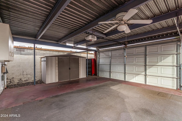 garage with ceiling fan, a garage door opener, and a carport