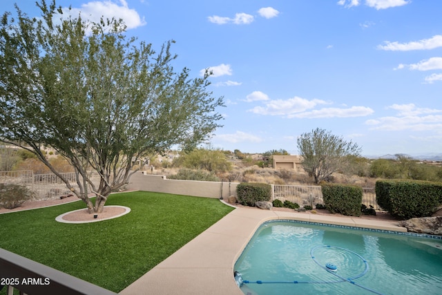 view of pool with a lawn